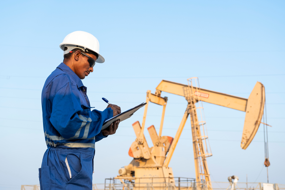 Oilfield Worker in Front of Drill